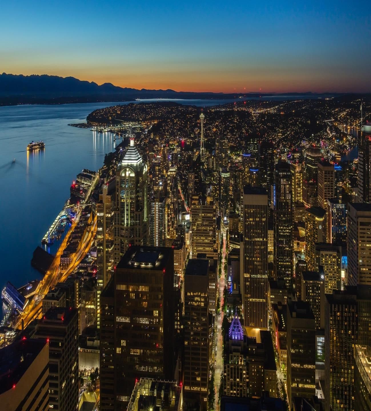 Seattle skyline at dusk over Elliott Bay, with the Space Needle and downtown